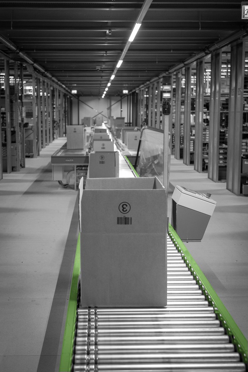 Boxes on a conveyor in the warehouse, ready for further processing.
